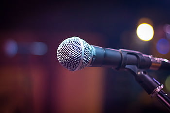 Dynamic micro on stand with blurred stage lights in background. HD wallpaper