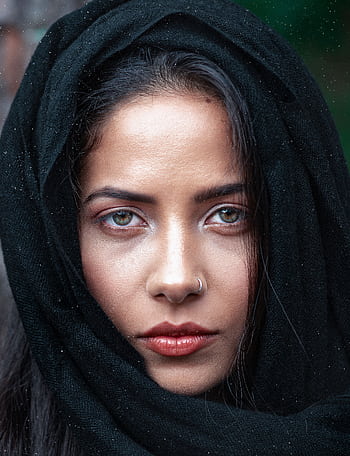 Close-up portrait of a woman with a nose ring in a black headscarf, showcasing her striking eyes. HD phone wallpaper