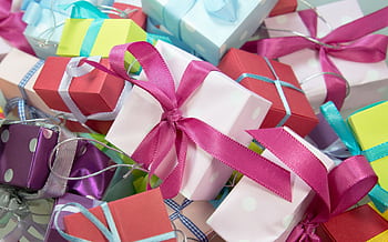 A vibrant collection of gift boxes with colorful ribbons, ideal for celebrations. HD wallpaper