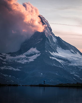 A stunning view of the Matterhorn mountain under a colorful sky at twilight. HD phone wallpaper