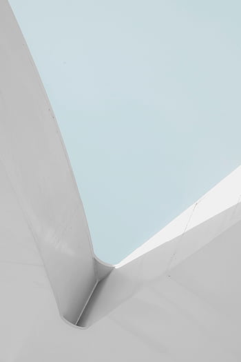 Minimalist architectural structure with a pastel blue sky, highlighting modern design. HD phone wallpaper