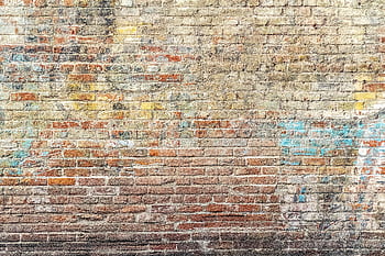 A vibrant weathered brick wall with graffiti art in Pasadena, CA. HD wallpaper