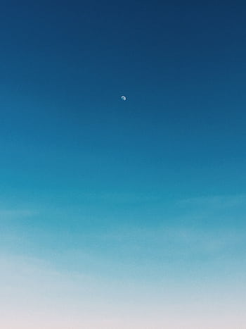 A tranquil blue sky with the moon visible above Devon, England. HD phone wallpaper