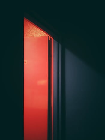 A captivating of an open door illuminated by a neon red light, creating a sense of mystery. HD phone wallpaper