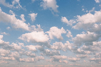 A serene view of fluffy cumulus clouds against a bright blue sky, perfect for backgrounds. HD wallpaper