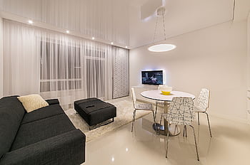 Sleek and stylish living room featuring modern furnishings and elegant lighting. HD wallpaper