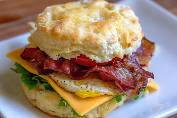 Delicious breakfast biscuit sandwich with bacon, egg, and cheese. Perfect for breakfast lovers. HD wallpaper