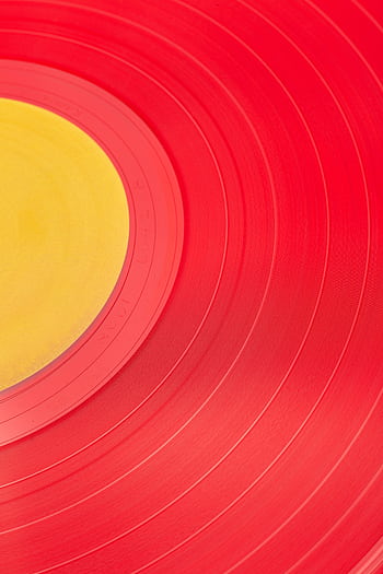 Vibrant red and yellow close-up of a vinyl record, perfect for music and design themes. HD phone wallpaper