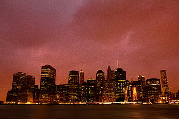 Beautiful view of the New York City skyline with city lights illuminating the dusk sky. HD wallpaper