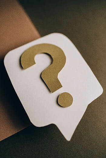Artistic paper craft of a question mark symbol on a textured green surface. Ideal for conceptual projects. HD phone wallpaper