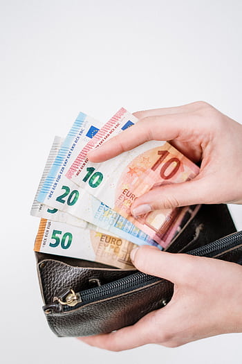 Close-up of a hand holding euro banknotes of different denominations, taken from a black wallet. HD phone wallpaper