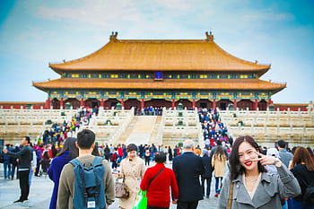 Tourists exploring the iconic Forbidden City in Beijing, a UNESCO World Heritage Site. HD wallpaper