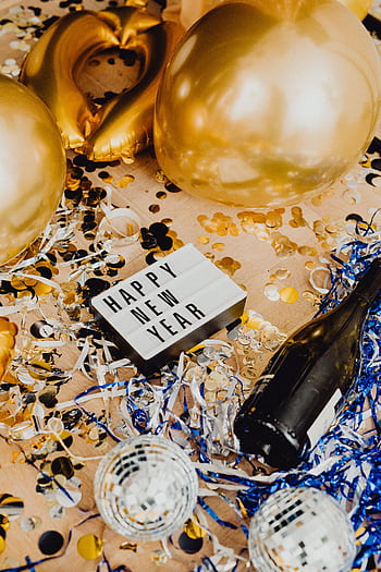 Festive New Year's scene with balloons, confetti, and party decorations. HD phone wallpaper