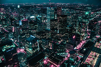 Explore a breathtaking aerial view of a modern city skyline illuminated at night. HD wallpaper