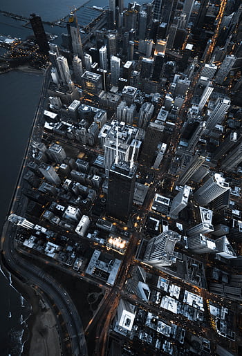 Dramatic aerial view of Chicago's illuminated skyline at twilight, showcasing iconic skyscrapers along the river. HD phone wallpaper