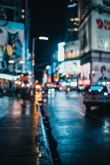 Moody, out-of-focus urban nightscape with neon city lights and wet streets. HD phone wallpaper