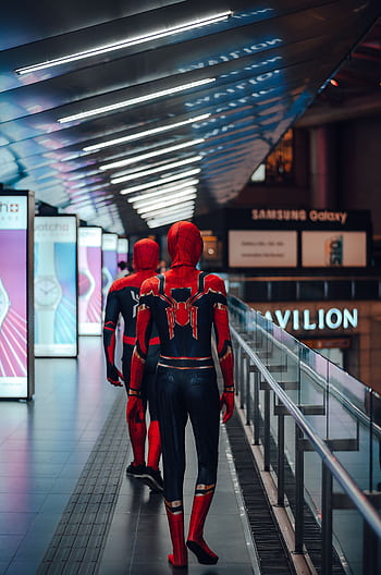 Two cosplayers dressed as Spider-Man walk through a brightly lit shopping mall in Kuala Lumpur. HD phone wallpaper