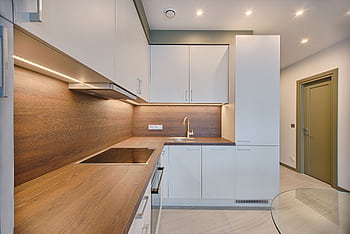 Modern kitchen interior with minimalistic design and wooden accents, captured with natural lighting. HD wallpaper