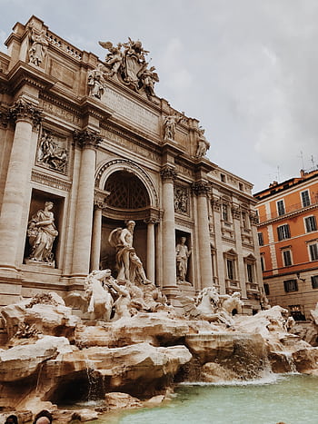 Capture the magnificence of the Trevi Fountain in Rome, showcasing intricate baroque architecture and sculptures. HD phone wallpaper