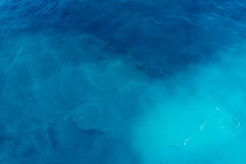 Calm and tranquil view of vibrant blue ocean waters, perfect for serene backgrounds. HD wallpaper