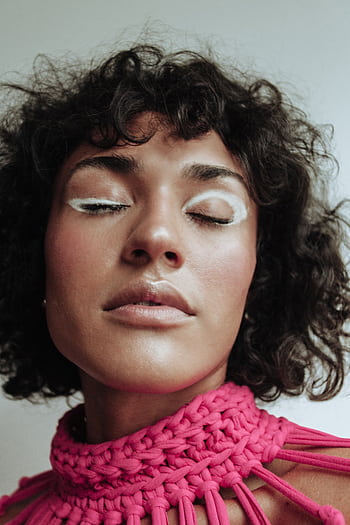 A close-up portrait of a woman with eye-catching creative makeup and a vibrant pink top. HD phone wallpaper