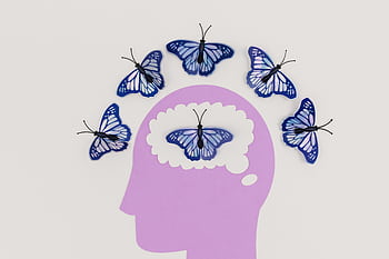 Creative illustration of butterflies representing thoughts over a brain silhouette. HD wallpaper