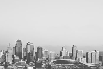 Black and white city skyline showcasing tall buildings and skyscrapers in a geometric layout. HD wallpaper