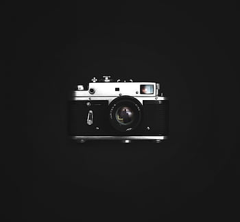 Classic film camera with a vintage look on a dark background, showcasing graphy nostalgia. HD wallpaper