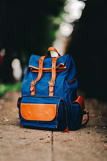 Close-up of a fashionable blue backpack on a city sidewalk in São Paulo. HD phone wallpaper