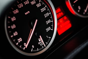Detailed view of car speedometer and odometer with illuminated red gauges. HD wallpaper