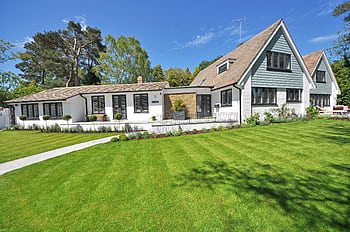 Contemporary house exterior with large manicured lawn and beautiful garden. HD wallpaper
