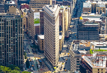 Stunning aerial view of the iconic Flatiron Building surrounded by Manhattan's bustling cityscape. HD wallpaper