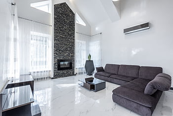 Elegant modern living room featuring a stone fireplace, sleek furniture, and airy ambiance. HD wallpaper