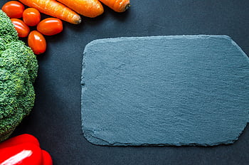Colorful vegetables on a slate board, perfect for healthy cooking themes. HD wallpaper