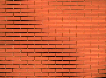 Orange brick wall with consistent pattern, perfect for background or texture use. HD wallpaper