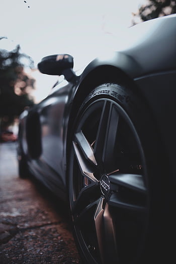 Close-up shot of a sleek, modern luxury sports car wheel with focus on design and details. HD phone wallpaper