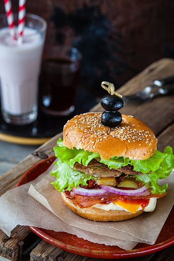Delicious gourmet burger with fresh ingredients, ideal for a flavorful lunch. HD phone wallpaper