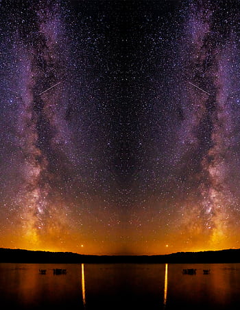 Breathtaking view of the Milky Way galaxy reflecting over a serene lake at night. HD phone wallpaper
