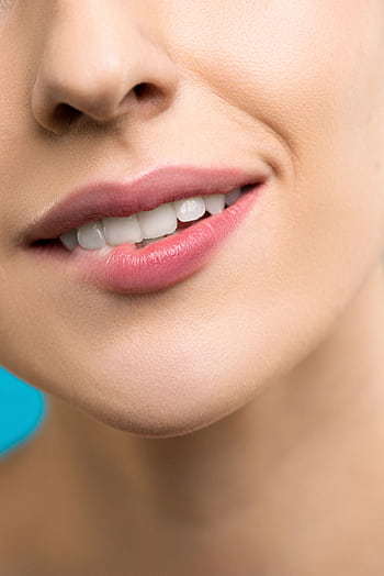 A detailed close-up of a woman's smile highlighting her lips and teeth with pink lipstick. HD phone wallpaper