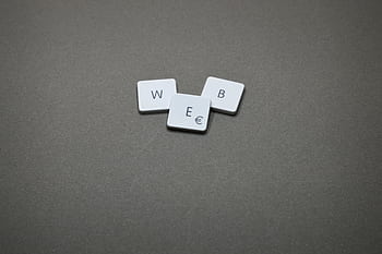 Minimalist of keyboard keys spelling 'WEB' on a plain background. HD wallpaper
