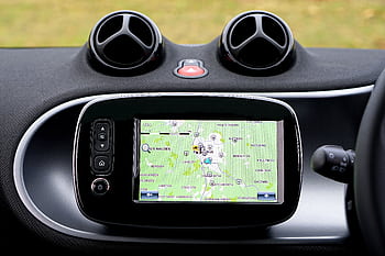Close-up view of a modern car dashboard featuring a GPS map for navigation. HD wallpaper
