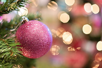 Vibrant pink Christmas ornament with bokeh lights, perfect for seasonal decorations. HD wallpaper