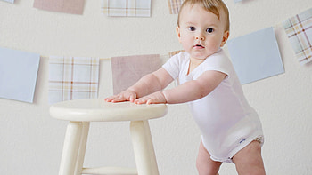 Cute Boy Baby Is Standing In Wall Background Wearing White Dress Cute HD wallpaper