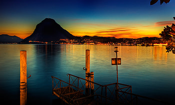 Sunset, blue, colorful, town, lamp, colors, pier, peaceful, houses, beauty, reflection, mountains, water, house, beautiful, lake, leaves, lights, view, clouds, nature, sky, lovely, splendor, evening HD wallpaper