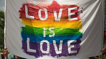 Colorful 'Love is Love' pride banner at a parade in London, Ontario celebrating equality and diversity. HD wallpaper