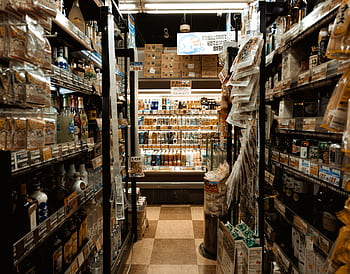 Explore a bustling Tokyo convenience store aisle packed with diverse products and merchandise. HD wallpaper
