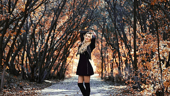 Blonde enjoying her afternoon walk, wooden scenery, pathway, blonde, black leather jacket, short black dress, fall, black thigh boots HD wallpaper