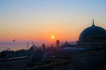 Beautiful view of Istanbul's mosques at sunset with vibrant sky and silhouettes. HD wallpaper