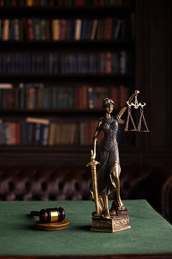 Lady Justice and gavel on a table in a classic law library setting. HD phone wallpaper