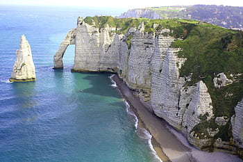 Scenic aerial view of the famous Étretat cliffs and beach in Normandy, France. A tranquil seascape with limestone formations. HD wallpaper